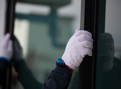 Technician carefully placing new Windows in Pekin IL
