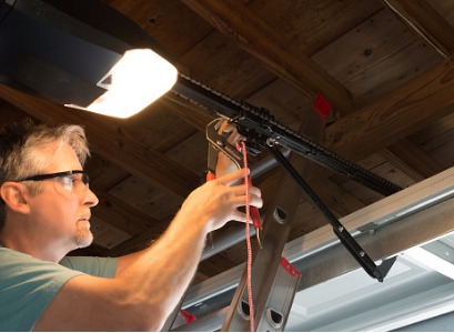 A technician performing Garage Door Repair in Peoria IL