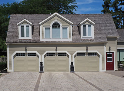 Three tan garage doors after Garage Door Repair in East Peoria IL